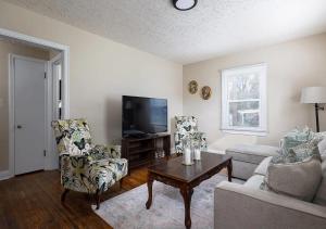 a living room with a couch and chairs and a tv at Amazing 4BD 2BA Home In Kentucky in Louisville