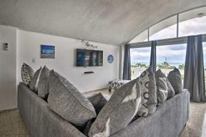 a living room with a couch with pillows at Peaceful Puerto Rico Paradise with Views and Balcony in Fajardo