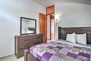ein Schlafzimmer mit einem Bett mit einem Spiegel und einer Kommode in der Unterkunft Peaceful Puerto Rico Paradise with Views and Balcony in Fajardo