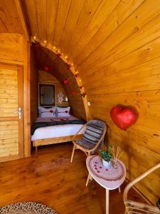 a bedroom with a bed in a wooden cabin at Moment's in Nature in Palmela