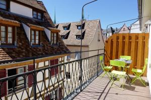 a patio with a table and chairs on a balcony at L'Appart du Quai avec Terrasse in Strasbourg
