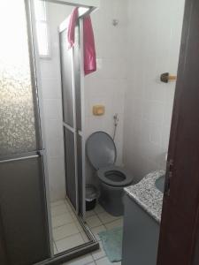 a small bathroom with a toilet and a sink at Ap 300m praia do morro in Guarapari