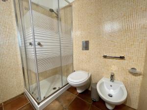 a bathroom with a shower and a toilet and a sink at Dammusi cala croce in Lampedusa