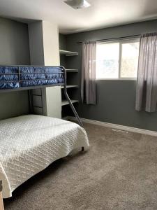 a bedroom with a bunk bed and a window at Sunny Days in Pocatello