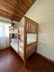 a bedroom with two bunk beds in a room at High-end Holiday Cabin - Tungurahua Hot Springs in Baños