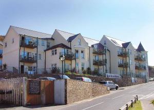 a large apartment building on the side of a street at Beachcombers in Newquay Bay Resort