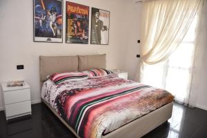 a bedroom with a bed with posters on the wall at Design & Comfort a Romano di L. in Romano di Lombardia