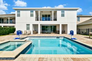 a house with a swimming pool in front of a house at ONIP - Luxurious Elite Home with Theater Room near Disney by Rentyl - 7604W in Orlando