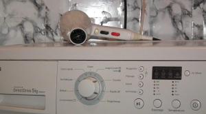 a brush sitting on top of a washing machine at StayHere, Nice Apartment with Garden and sea view, 1 min walk From Beach, High-Speed WI-FI in El Jadida +48 photos