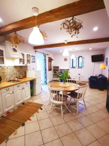 a kitchen and dining room with a table and chairs at Mazurski Ogród - dom z ogrodem, kominkiem i wiatą biesiadną in Wydminy