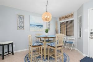 a dining room with a table and chairs at Windjammer 403 in Cedar Landing