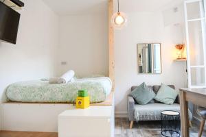 a bedroom with a bed and a chair at Studio cosy avec terrasse au coeur de Marseille in Marseille