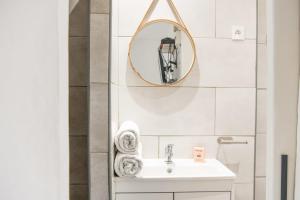 a bathroom with a sink and a mirror at Studio cosy avec terrasse au coeur de Marseille in Marseille