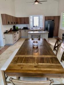 a large kitchen with a wooden table in the middle at Haven Hill Place (New!!!) 