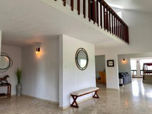 a living room with a bench and a mirror at Haven Hill Place (New!!!) 