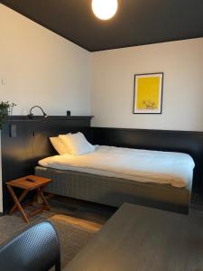 a bedroom with a bed and a table at Magnolia House Sollentuna in Sollentuna