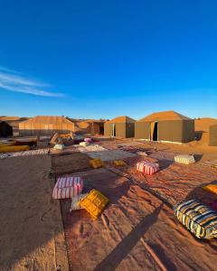 a desert with tents and pillows on the ground at Bivouac Luna in Mhamid