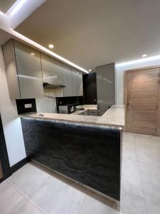 a large kitchen with a black counter top at Luxury apartment in Casablanca in Casablanca