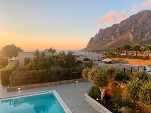 a villa with a swimming pool and a view of the ocean at Villa Antares in Custonaci