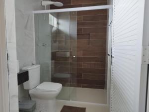 a bathroom with a toilet and a shower at Bless in Maragogi