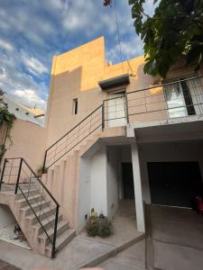 a house with a staircase in front of it at Tierras del Malbec 1 in Ciudad Lujan de Cuyo