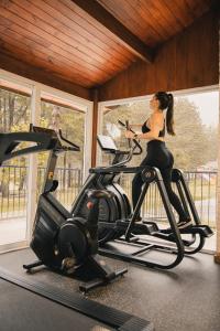 a woman on a treadmill in a gym at Pousada O Cantinho da Raposa in Monte Verde