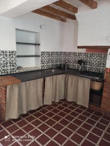 a kitchen with a counter top in a room at Finca Riolavar in Jubrique