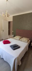 a bedroom with a bed with two towels on it at LA CASA in Cagnes-sur-Mer
