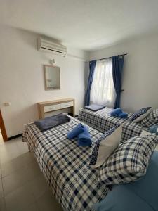 2 łóżka w pokoju z niebieskimi poduszkami w obiekcie CASA SANDRA COCOSOL w mieście Costa de Antigua
