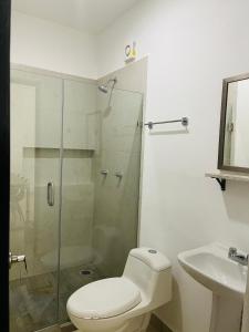a bathroom with a shower and a toilet and a sink at Nuevo departamento a solo 3 min de la playa con todos los servicios in La Florida