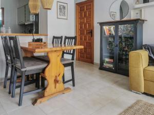 una sala da pranzo con tavolo e sedie in legno di Casa Del Angel , Cosy 2 bed apartment,150m from Playa Los Locos plus beautiful swimming pool a Torrevieja