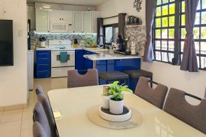 a kitchen and dining room with a table and chairs at Coastal Puerto Rican Apartment - Walk to Beach! in Rio Grande