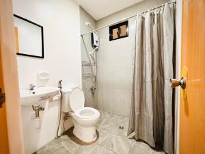 a bathroom with a toilet and a sink and a shower at RJC Building in Olongapo
