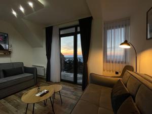 a living room with a couch and a table at Gencian resort in Kopaonik