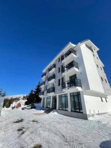 a building on top of a snow covered slope at Gencian resort in Kopaonik