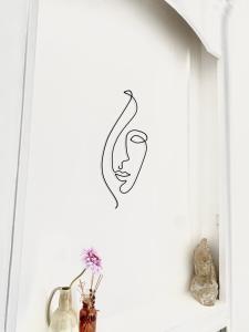 a wall art with a woman on a hook at Cosy T2 in Neuilly sur Seine metro 1 in Neuilly-sur-Seine