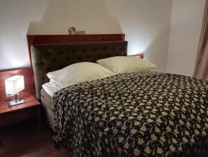 a bedroom with a bed with a black and white comforter at Freundsheimhof in Kramsach