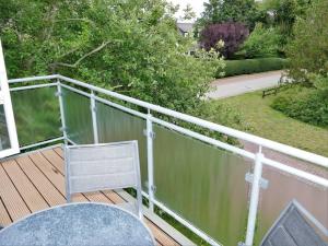 a balcony with a table and a chair on a deck at Ferienwohnung: Utkiek in Langeoog