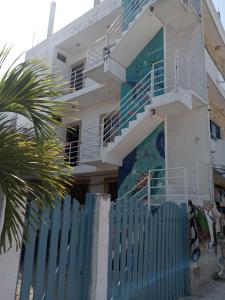 a building with a blue fence in front of it at El Mirador Holbox in Holbox Island