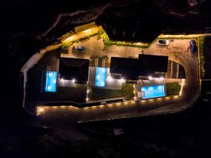 an aerial view of a house at night with lights at Mani Theasis in Stoupa