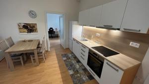 a kitchen with a table and a dining room at V srdci mesta in Gerlachov