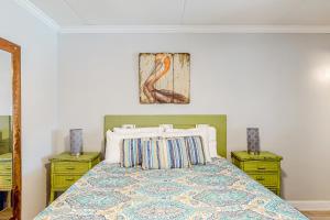 a bedroom with a bed with two yellow night stands at Beachview 204 in Gulf Shores