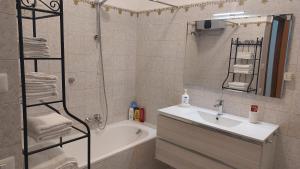 a bathroom with a sink and a tub and a shower at Appartamento da Miriam in Lido di Ostia +27 photos