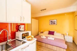mały pokój z łóżkiem i kuchnią w obiekcie Apartmani Niki ZVEKOVICA w mieście Cavtat
