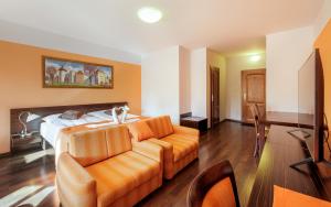 a living room with a bed and a couch at Apartmány Sladký sen in Kežmarok