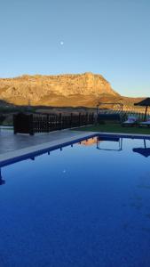 a pool of water with a mountain in the background at Casa rural La Pradera in Villanueva de la Concepción +9 photos