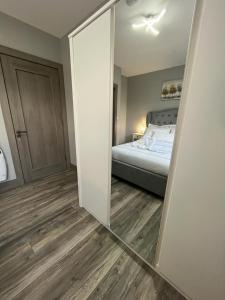 a mirror in a room with a bed and a bedroom at Horseleap BNB in Moate