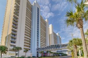 a tall building with palm trees in front of it at Majestic Beach Resort Tower 2- 1805 in Panama City Beach