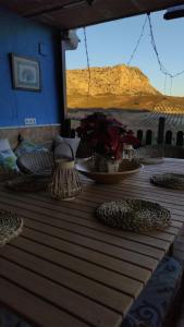 a wooden table with a view of a mountain at Casa rural La Pradera in Villanueva de la Concepción