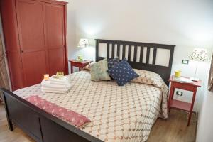 
a bedroom with a bed and a dresser at La Dimora Di Odisseo in Trapani
